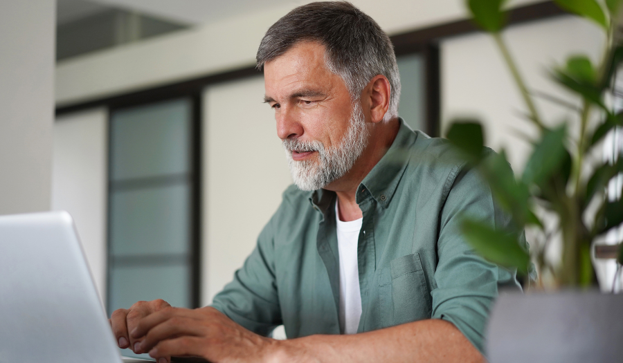 A man looks at his laptop computer