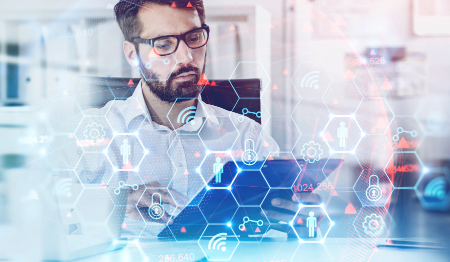 A mortgage professional working a laptop with an overlay of blue hexagons with icons representing digital transformation and the digitization of mortgage processes.
