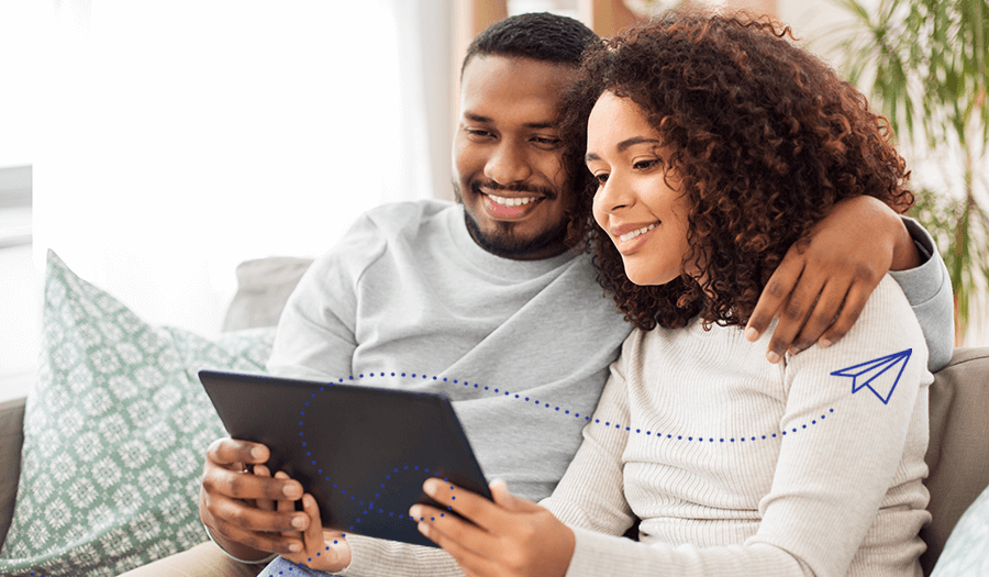 A couple looking at a laptop to try and increase their digital mortgage technology vocabulary with Stavvy 